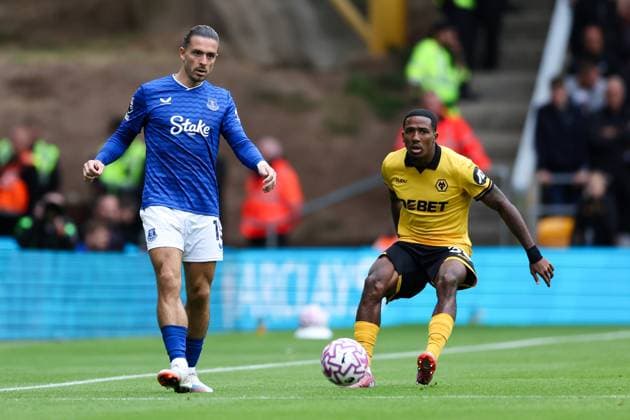Wolverhampton, England, 30th August 2025. Jack Grealish of Everton passes the ball whilst under pressure from Jackson Tchatchoua of Wolverhampton Wanderers during the Wolverhampton Wanderers vs Everton Premier League match at Molineux, Wolverhampton. Picture credit should read: Jessica Hornby Sportimage EDITORIAL USE ONLY. No use with unauthorised audio, video, data, fixture lists, club league logos or live services. Online in-match use limited to 120 images, no video emulation. No use in betting, games or single club league player publications. SPI_043_JH_WOLVES_EVERTON SPI-4096-0043