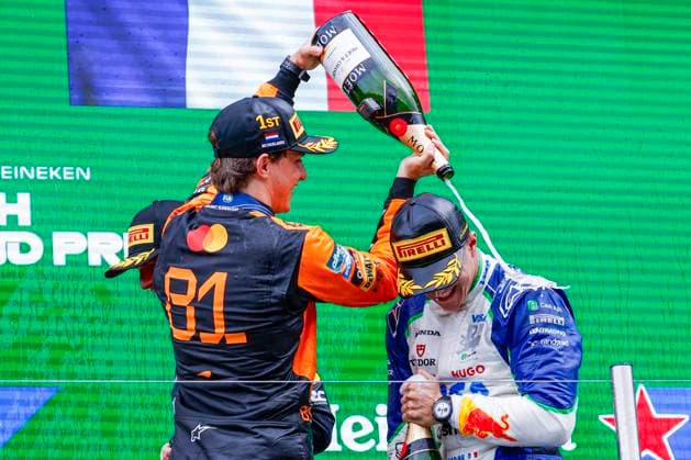 podium ceremony, Isack Hadjar of France and Visa Cash App Racing Bulls gets a champagne shower from Oscar Piastri of Australia and McLaren F1 Team during the Formula 1 Heineken Dutch Grand Prix 2025 on Day 3 at Circuit Zandvoort on August 31, 2025 in Zandvoort, Netherlands. (Photo by Marcel ter Bals DeFodi Images)
