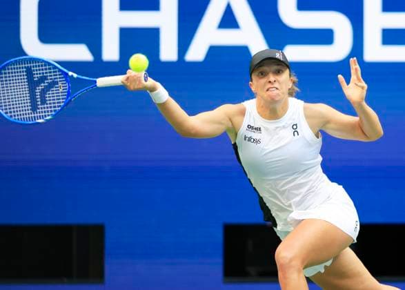 Iga Swiatek of Poland returns a ball to Amanda Anisimova in the second set in the quarterfinals in Arthur Ashe Stadium on day 11 at the 2025 US Open Tennis Championship at the USTA Billie Jean King National Tennis Center in New York City on Wednesday, September 3, 2025. Anisimova defeated Swiatek 6-4, 6-3 and advanced to the semifinals.  NYP20250903108 JOHNxANGELILLO