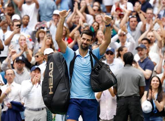 Novak Djokovic of Serbia waves to fans after losing to Carlos Alcaraz of Spain in a Men s semifinal match at the 2025 US Open Tennis Championship at the USTA Billie Jean King National Tennis Center in New York City on Friday, September 5, 2025. Alcaraz won 6-4, 7-6, 6-2 and advances to the finals on Sunday.  NYP20250905933 JOHNxANGELILLO