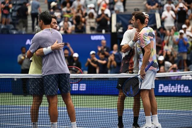 (250907) -- NEW YORK, Sept. 7, 2025 -- Marcel Granollers (front R) Horacio Zeballos (front L) and Joe Salisbury (back R) Neal Skupski hug after the men s doubles final match between Marcel Granollers of Spain Horacio Zeballos of Argentina and Joe Salisbury Neal Skupski of Britain at the 2025 US Open tennis championships in New York, the United States, Sept. 6, 2025. ) (SP)U.S.-NEW YORK-TENNIS-US OPEN-MEN S DOUBLES-FINAL LixRui 