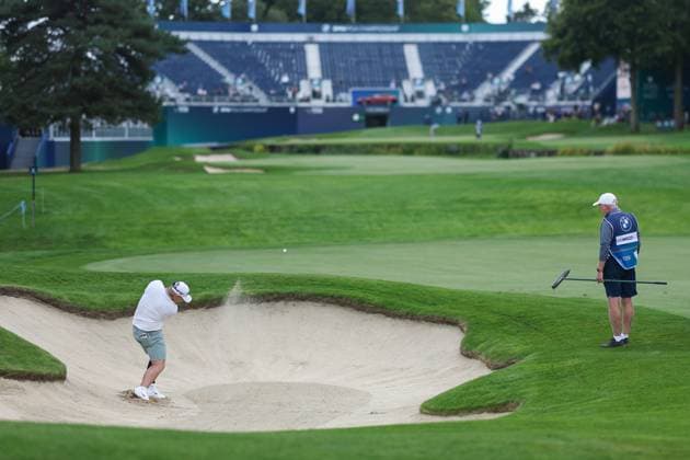 9th September 2025; Wentworth Club, London, England; The BMW PGA, Golf Herren Championship Golf Practice Day 1; A general view on the 18th green with a player splashing from the greenside bunker  HenningxvonxJagow