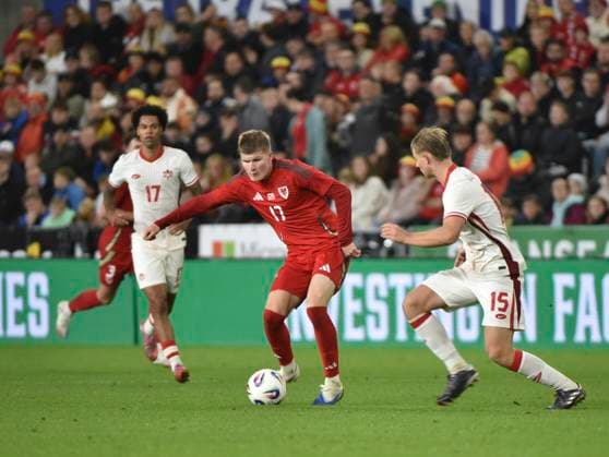 9th September 2025; Swansea.com Stadium, Swansea, Wales; Friendly International Football, Wales versus Canada; Jordan James of Wales holds off Luc De Fougerolles of Canada  AledxHopkins