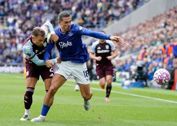 Liverpool, England, 13th September 2025. Jack Grealish of Everton (R) is challenged by Matty Cash of Aston Villa during the Everton vs Aston Villa Premier League match at Hill Dickinson Stadium, Liverpool. Picture credit should read: Andrew Yates Sportimage EDITORIAL USE ONLY. No use with unauthorised audio, video, data, fixture lists, club league logos or live services. Online in-match use limited to 120 images, no video emulation. No use in betting, games or single club league player publications. SPI_009_AY_EVERTON_VILLA SPI-4134-0008