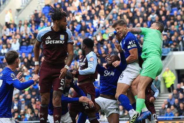 13th September 2025; Hill Dickinson Stadium, Liverpool, England; Premier League Football, Everton versus Aston Villa; Everton goalkeeper Jordan Pickford leaps to punch a clearance under pressure from Tyrone Mings of Aston Villa  DavidxBlunsden