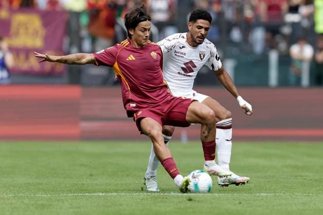 Italy: Serie a football match AS Roma vs Torino Roma™s Argentinian forward Paulo Dybala challenges for the ball with Torino s Equatoguinean defender Saul Coco during the Serie A football match between AS Roma vs Torino at the Olimpico Stadium in Rome, Italy on September 14, 2025. _BPH8123 Copyright: xAntonioxBalascox