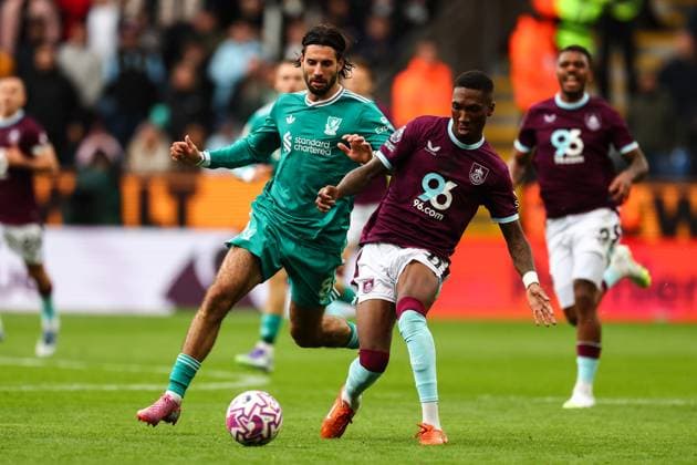 Burnley, England, 14th September 2025. Jaidon Anthony of Burnley passes the ball under pressure from Dominik Szoboszlai of Liverpool during the Burnley vs Liverpool Premier League match at Turf Moor, Burnley. Picture credit should read: Simon Bellis Sportimage EDITORIAL USE ONLY. No use with unauthorised audio, video, data, fixture lists, club league logos or live services. Online in-match use limited to 120 images, no video emulation. No use in betting, games or single club league player publications. SPI_035_SB_BURNLEY_LIVERPOOL SPI-4138-0035