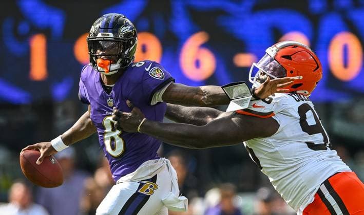 Baltimore Ravens quarterback Lamar Jackson (8) shakes off Cleveland Browns defensive tackle Maliek Collins (96) during a first down pass to Baltimore Ravens wide receiver Zay Flowers during the third quarter of the Ravens home opener at M&T Bank Stadium in Baltimore, Maryland, on Sunday, September 14, 2025.  BAL20250914137 DAVIDxTULIS