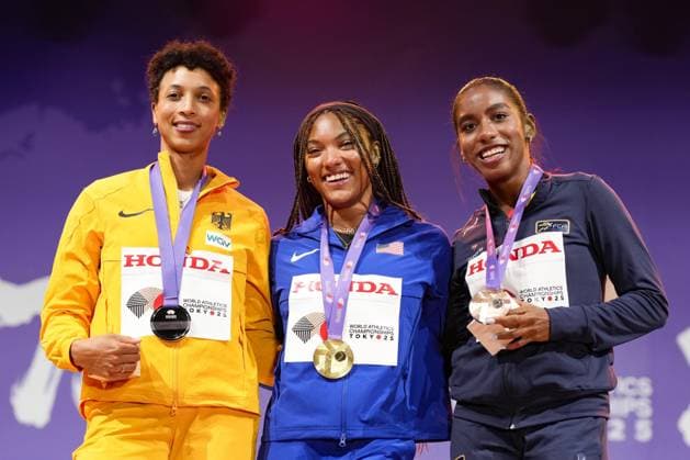 Athletics: World championships in Tokyo Gold medalist Tara Davis-Woodhall (C) of the United States poses on the podium during a medal ceremony for the women s long jump event at the World Athletics Championships at the National Stadium in Tokyo on Sept. 15, 2025, alongside silver medalist Malaika Mihambo (L) of Germany and bronze medalist Natalia Linares of Colombia.  A14AA0004851325P