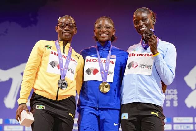 Athletics: World championships in Tokyo Gold medalist Melissa Jefferson-Wooden (C) of the United States poses on the podium during the medal ceremony for the women s 100-meter event at the World Athletics Championships at the National Stadium in Tokyo on Sept. 15, 2025, alongside silver medalist Tina Clayton (L) of Jamaica and bronze medalist Julien Alfred of Saint Lucia.  A14AA0004851383P