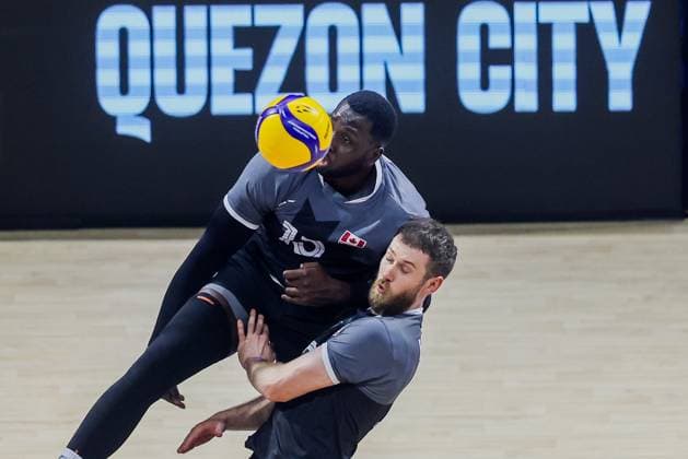 (250915) -- QUEZON CITY, Sept. 15, 2025 -- Isaac Heslinga (R) and Sharone Vernon-Evans of Canada compete during the pool G match between Canada and Japan at the FIVB Men s World Championship, WM, Weltmeisterschaft 2025 in Quezon City, the Philippines, on Sept. 15, 2025. ) (SP) THE PHILIPPINES-QUEZON CITY-FIVB MEN S WORLD CHAMPIONSHIP 2025-CAN VS JPN ROUELLExUMALI 