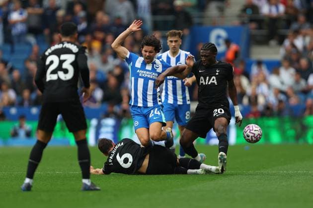 Football - 2025 2026 Premier League - Brighton & Hove Albion vs Tottenham Hotspur - Amex Stadium - Saturday 20th September 2025 Joao Palhinha of Tottenham Hotspur slides in to win the ball from Ferdi Kadioglu of Brighton during the Premier League match at the Amex Stadium COLORSPORT Shaun Boggust 