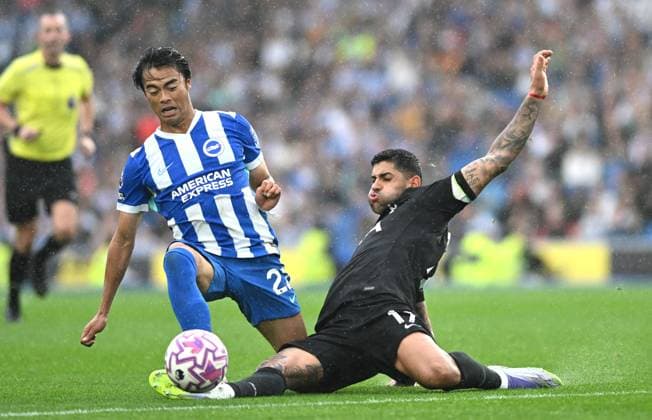 Kaoru Mitoma of Brighton is tackled by Cristian Romero of Spurs during the Premier League match between Brighton and Hove Albion and Tottenham Hotspur at the American Express Stadium , Brighton , UK - 20th September 2025 Brighton & Hove Albion v Tottenham Hotspur Premier League Football, Amex Stadium, Sussex, United Kingdom - 20 Sep 2025Brighton Amex Stadium Sussex United Kingdom Editorial use only. No merchandising. For Football images FA and Premier League restrictions apply inc. no internet mobile usage without FAPL license - for details contact Football Dataco  Copyright: xSimonxDack Shutterstockx 15495909ag