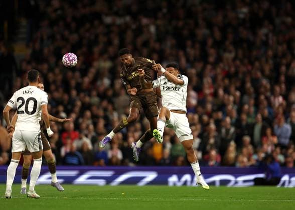 20th September 2025; Craven Cottage, Fulham, London, England; Premier League Football, Fulham versus Brentford; Ethan Pinnock of Brentford heads the ball over Rodrigo Muniz of Fulham  JohnxPatrickxFletcher