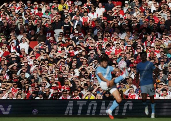 London, England, 21st September 2025. Fans look on in the sunshine during the Arsenal vs Manchester City Premier League match at the Emirates Stadium, London. Picture credit should read: David Klein Sportimage EDITORIAL USE ONLY. No use with unauthorised audio, video, data, fixture lists, club league logos or live services. Online in-match use limited to 120 images, no video emulation. No use in betting, games or single club league player publications. SPI_036_DK_Arsenal_Man_City SPI-4152-0040