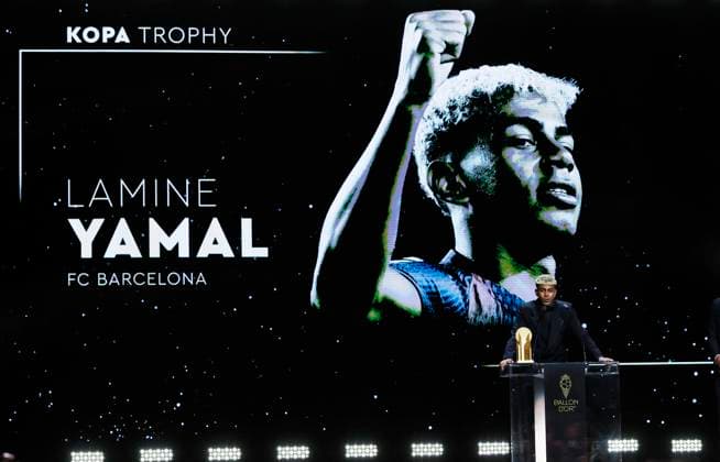 (250923) -- PARIS, Sept. 23, 2025 -- Barcelona s Spanish player Lamine Yamal speaks after receiving the Kopa Trophy for the best under-21 player during the 2025 Ballon d Or France Football award ceremony at the Theatre du Chatelet in Paris, France, on Sept. 22, 2025. ) (SP)FRANCE-PARIS-FOOTBALL-BALLON D OR CEREMONY GaoxJing 