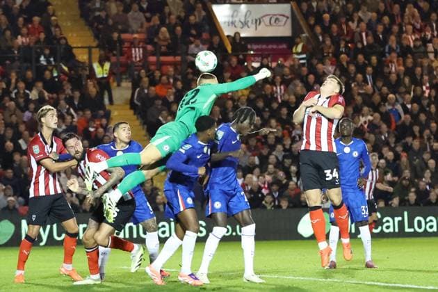 Lincoln City v Chelsea EFL Cup 23 09 2025. Chelsea goalkeeper Filip Jorgensen (12) misses his punch during the EFL Cup match between Lincoln City and Chelsea at Sincil Bank, Lincoln, United Kingdom on 23 September 2025. Lincoln Sincil Bank Lincs United Kingdom Editorial use only DataCo restrictions apply See www.football-dataco.com , Copyright: xJohnxMallettx PSI-22888-0035