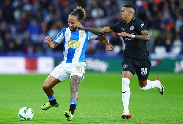 Marcus Harness of Huddersfield Town and Savinho of Manchester City Huddersfield Town v Manchester City, EFL Carabao Cup, Third Round, Football, Accu Stadium, Huddersfield, UK - 24 Sep 2025Huddersfield Accu Stadium United Kingdom EDITORIAL USE ONLY No use with unauthorised audio, video, data, fixture lists, club league logos or live services. Online in-match use limited to 120 images, no video emulation. No use in betting, games or single club league player publications. Copyright: xMattxWest Shutterstockx 15498595ah