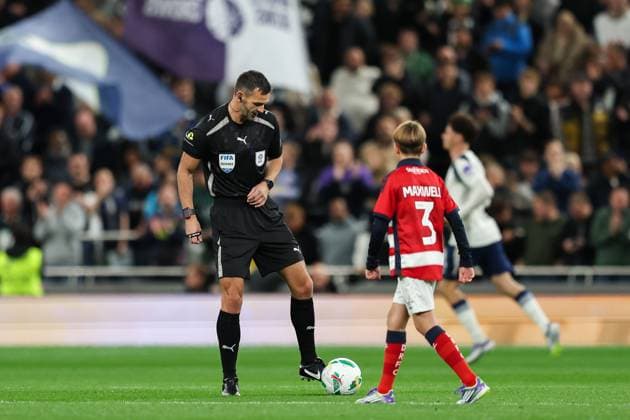 24th September 2025; Tottenham Hotspur Stadium, London, England; Carabao Cup Football, Tottenham Hotspur versus Doncaster Rovers; Referee Andrew Madley kicking the ball to a Doncaster Rovers ball boy  HenningxvonxJagow