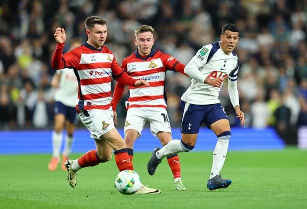 Pedro Porro of Tottenham Hotspur competes for the ball with Ian Lawlor of Doncaster Rovers and Glenn Middleton of Doncaster Rovers Tottenham Hotspur v Doncaster Rovers, EFL Carabao Cup, Third Round, Football, Tottenham Hotspur Stadium, London, UK - 24 Sep 2025London Tottenham Hotspur Stadium United Kingdom EDITORIAL USE ONLY No use with unauthorised audio, video, data, fixture lists, club league logos or live services. Online in-match use limited to 120 images, no video emulation. No use in betting, games or single club league player publications.  Copyright: xMichaelxZemanek Shutterstockx 15498598t