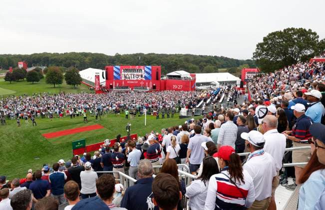 Crowds of spectators stand for the National Anthem during the opening ceremony for the 45th Ryder Cup at The Black Course at Bethpage State Park in Farmingdale, New York, on Wednesday, September 24, 2025. The three-day golf tournament starts on Friday, September 26, 2025.  RYD20250924838 JOHNxANGELILLO