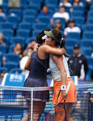(250925) -- BEIJING, Sept. 25, 2025 -- Zhu Lin (R) hugs Uchijima Moyuka after the women s singles first round match between Zhu Lin of China and Uchijima Moyuka of Japan at 2025 China Open tennis tournament in Beijing, China, Sept. 25, 2025. ) (SP)CHINA-BEIJING-TENNIS-CHINA OPEN-WOMEN S SINGLES-FIRST ROUND (CN) DuxXinyi 