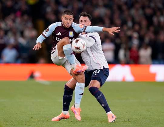 Birmingham, England, 25th September 2025. Emiliano Buendia of Aston Villa tussles with Nadir Zortea of Bologna during the Aston Villa vs Bologna UEFA Europa League match at Villa Park, Birmingham. Picture credit should read: Andrew Yates Sportimage EDITORIAL USE ONLY. No use with unauthorised audio, video, data, fixture lists, club league logos or live services. Online in-match use limited to 120 images, no video emulation. No use in betting, games or single club league player publications. SPI_008_AY_Villa_Bologna SPI-4162-0008