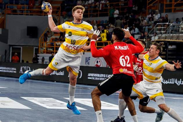 (250927) -- CAIRO, Sept. 27, 2025 -- Louis Delpire (top) of Sydney Uni HC shoots during the 18th IHF Men s Club World Championship, WM, Weltmeisterschaft 2025 preliminary round group C handball match between Al Ahly SC of Egypt and Sydney Uni HC of Australia in Cairo, Egypt, on Sept. 26, 2025. ) (SP)EGYPT-CAIRO-HANDBALL-IHF-MEN S CLUB WORLD CHAMPIONSHIP-PRELIMINARY ROUND MATCH AhmedxGomaa 
