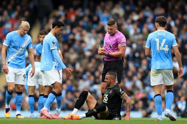 27th September 2025; Etihad Stadium, Manchester, England; Premier League Football, Manchester City versus Burnley; referee Robert Jones shows a yellow card to Kyle Walker of Burnley for a foul on Phil Foden of Manchester City  DavidxBlunsden