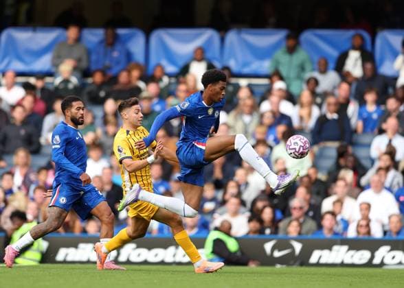 27th September 2025; Stamford Bridge, Chelsea, London, England: Premier League Football, Chelsea versus Brighton and Hove Albion; Josh-Kofi Acheampong of Chelsea challenged by Stefanos Tzimas of Brighton &amp; Hove Albion  JohnxPatrickxFletcher