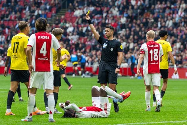 AMSTERDAM , 27-09-2025 , Johan Cruyff ArenA , season 2025 2026 , Dutch Eredivisie football . Match between Ajax and NAC Breda , Picture shows referee Marc Nagtegaal showing a yellow card to NAC Breda player Max Balard (final score 2-1). Ajax - NAC  x31226454x Copyright: