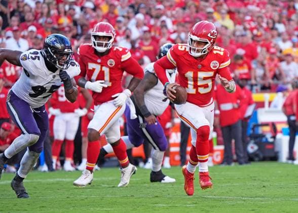 Kansas City Chiefs quarterback Patrick Mahomes (15) scrambles against Baltimore Ravens linebacker Tavius Robinson (95) at Arrowhead Stadium in Kansas City, Missouri on Sunday, September 28, 2025.  KCP2025092811 JONxROBICHAUD