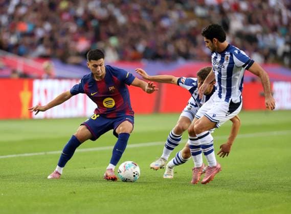 September 28, 2025, Sabadell, Barcelona, Spain: Barcelona Spain 28.09.202 Roony Bardghji FC Barcelona, Barca , Aihen MuoÂ±oz (Real Sociedad) and GonoÂßalo Guedes (Real Sociedad) battle for the ball during the La Liga EA Sports between FC Barcelona and Real Sociedad at Estadi Olimpic Lluis Companys on 28 September 2025 in Barcelona. Sabadell Spain - ZUMAu50_ 20250928_zsp_u50_078 Copyright: xXavixUrgelesx