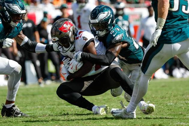 September 28, 2025, Tampa, Florida, USA: Tampa Bay Buccaneers wide receiver Chris Godwin Jr. 14 catches a pass and is tacked by Philadelphia Eagles safety Andrew Mukuba 24 during the fourth quarter at Raymond James Stadium in Tampa on Sunday, Sept. 28, 2025. Tampa USA - ZUMAs70_ 20250928_zan_s70_068 Copyright: xJeffereexWoox Tampa USA - ZUMA0835 20250928_zan_s70_068 Copyright: xIMAGO JeffereexWoox