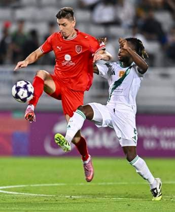 AFC CHAMPIONS LEAGUE ELITE, AL DUHAIL SC (QAT) V AL AHLI SAUDI FC (KSA) Krzysztof Piatek (L) of Al Duhail SC and Valentin Atangana of Al Ahli Saudi FC in action during the AFC Champions League elite west football match between Qatar s Al Duhail SC and Saudi Arabia s Al Ahli Saudi FC at Abdullah Bin Khalifa Stadium in Doha, Qatar, on September 29, 2025. DOHA Qatar Copyright: xNAUSHADx
