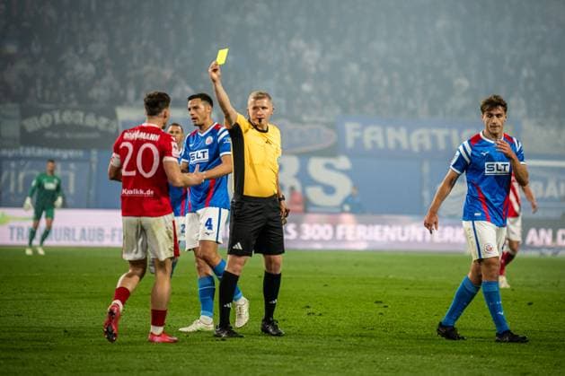 Rostock, Deutschland 30. September 2025: 3. Liga - 2025 2026 - FC Hansa Rostock vs. FC Energie Cottbus Im Bild: v.li. Axel Borgmann (Energie Cottbus) bekomt Gelb, gelbe Karte, von 3v.li. Schiedsrichter Timo Gansloweit (Dortmund) DFB regulations prohibit any use of photographs as image sequences and or quasi-video. Copyright: xFotostandx xVoelkerx