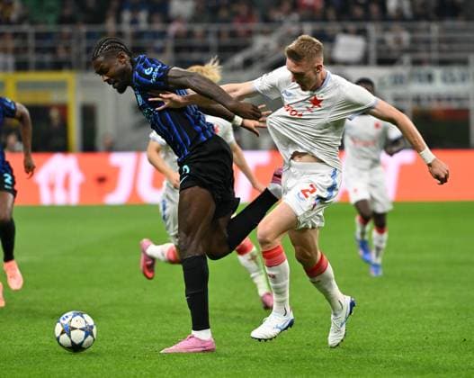 (251001) -- MILAN, Oct. 1, 2025 -- Inter Milan s Marcus Thuram (L) vies with Salvia Praha s Stepan Chaloupek during the UEFA Champions League match between Inter Milan and Slavia Praha in Milan, Italy, Sept.30, 2025. (SP)ITALY-MILAN-FOOTBALL-UEFA CHAMPIONS LEAGUE-INTER MILAN VS SLAVIA PRAHA LixJing 