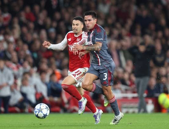 London, England, 1st October 2025. Gabriel Martinelli of Arsenal tussles with Francisco Ortega of Olympiakos during the Arsenal vs Olympiacos UEFA Champions League match at the Emirates Stadium, London. Picture credit should read: David Klein Sportimage EDITORIAL USE ONLY. No use with unauthorised audio, video, data, fixture lists, club league logos or live services. Online in-match use limited to 120 images, no video emulation. No use in betting, games or single club league player publications. SPI_023_DK_Arsenal_Olympiakos SPI-4186-0028