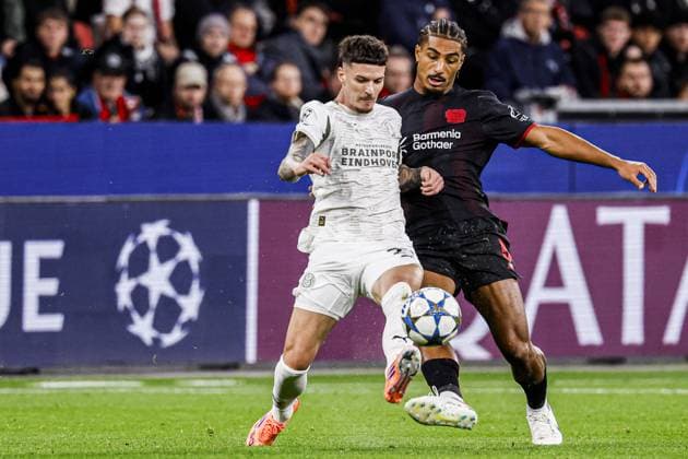 Dennis Man of PSV Eindhoven battles for possession with Loic Bade of Bayer 04 Leverkusen Bayer 04 Leverkusen v PSV Eindhoven, UEFA Champions League 2025 26 League Phase MD2, Bayer 04 Leverkusen v PSV Eindhoven, BayArena, October 1, 2025, Leverkusen, Germany.
