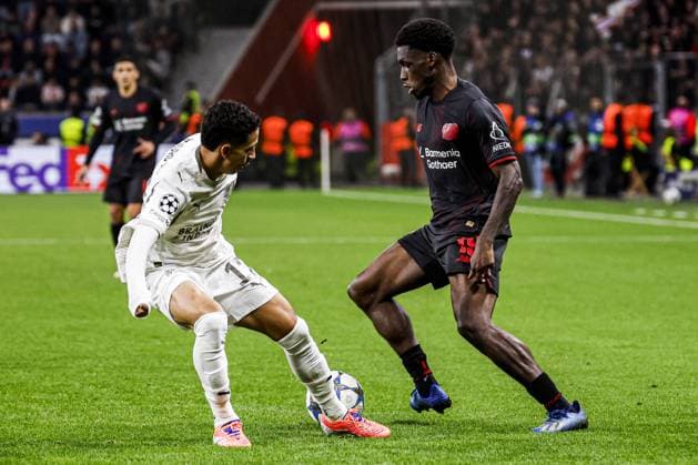 Ernest Poku of Bayer 04 Leverkusen battles for possession with Mauro Junior of PSV Eindhoven Bayer 04 Leverkusen v PSV Eindhoven, UEFA Champions League 2025 26 League Phase MD2, Bayer 04 Leverkusen v PSV Eindhoven, BayArena, October 1, 2025, Leverkusen, Germany.