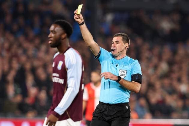 2025-10-02 Feyenoord v Aston Villa - UEFA Europa League, League phase, MD2 ROTTERDAM, NETHERLANDS - OCTOBER 2: Referee Rade Obrenovic shows the yellow card to Goalkeeper Marco Bizot of Aston Villa during the UEFA Europa League, League phase, MD2 match between Feyenoord and Aston Villa at Stadion Feijenoord on October 2, 2025 in Rotterdam, Netherlands. Rotterdam Stadion Feijenoord Netherlands Content not available for redistribution in The Netherlands directly or indirectly through any third parties. Copyright: xHansxvanxderxValkx