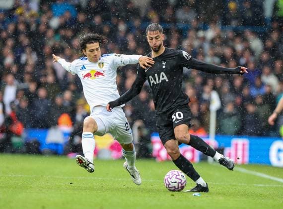 Leeds, England, 4th October 2025. Ao Tanaka (L) of Leeds United in action with Rodrigo Bentancur of Tottenham Hotspur during the Leeds United vs Tottenham Hotspur Premier League match at Elland Road, Leeds. Picture credit should read: Nigel Roddis Sportimage EDITORIAL USE ONLY. No use with unauthorised audio, video, data, fixture lists, club league logos or live services. Online in-match use limited to 120 images, no video emulation. No use in betting, games or single club league player publications. SPI_020_NR_LEED_TOTE SPI-4193-0020