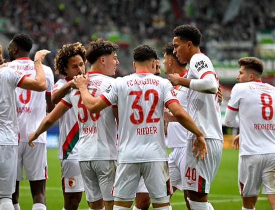 04.10.2025, Fussball 1. Bundesliga 2025 2026, 6.Spieltag, FC Augsburg - VfL Wolfsburg, in der WWK-Arena Augsburg. Mert Kömür (FC Augsburg) jubelt mit Noahkai Dominic Banks (FC Augsburg)