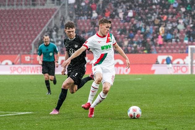 1. Bundesliga 2025 2026 - 6. Spieltag 04.10.2025 - FC Augsburg vs.VfL Wolfsburg - WWK Arena (Augsburg, Deutschland); Andreas Skov Olsen (VfL Wolfsburg), Anton Kade (FC Augsburg) Copyright: xLukaxKolanovicx