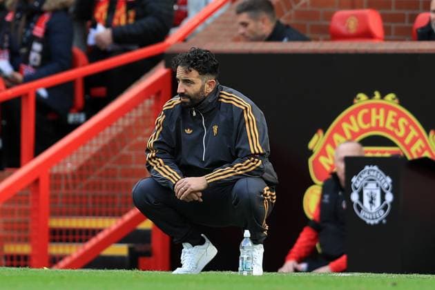 4th October 2025; Old Trafford, Manchester, England; Premier League Football, Manchester United, ManU versus Sunderland; Manchester United manager Ruben Amorim sits on his haunches as he follows the action from the touchline  DavidxBlunsden
