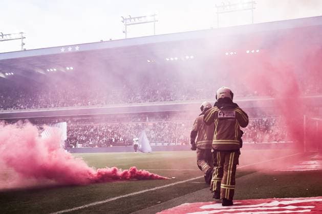 Fire brigade members pictured on the field with smoke fire works ahead of a soccer match between RSC Anderlecht and Standard de Liege, Sunday 05 October 2025 in Anderlecht, on day 10 of the 2025-2026 Jupiler Pro League first division of the Belgian championship. BRUNOxFAHY  x136122723x
