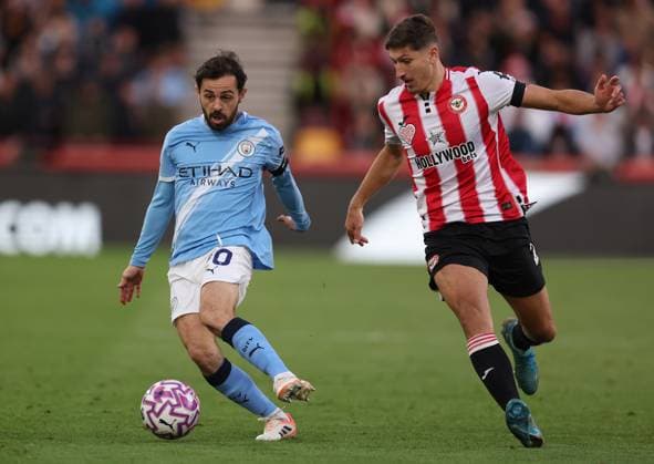 London, England, 5th October 2025. Bernardo Silva of Manchester City and Vitaly Janelt of Brentford challenge for the ball during the Brentford vs Manchester City Premier League match at Gtech Community Stadium, London. Picture credit should read: Paul Terry Sportimage EDITORIAL USE ONLY. No use with unauthorised audio, video, data, fixture lists, club league logos or live services. Online in-match use limited to 120 images, no video emulation. No use in betting, games or single club league player publications. SPI_046_PT_Brentford_Man_City SPI-4202-0046