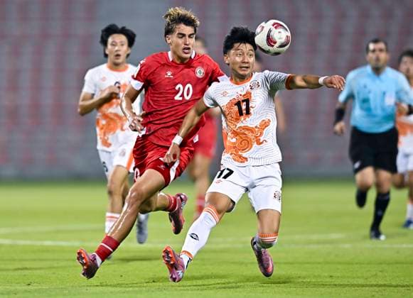 LEBANON v BHUTAN-AFC ASIAN CUP 2027 QUALIFIER THIRD ROUND Samy Merheg (L) of Lebanon and Kelzang Jigme of Bhutan in action during the AFC Asian Cup 2027 Qualifier third round Group B match between Lebanon and Bhutan at Grand Hamad Stadium in Doha, Qatar, on October 9, 2025. DOHA Qatar Copyright: xNOUSHADx