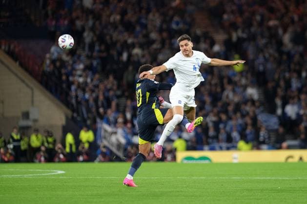 UK: Scotland v Greece, UEFA World Cup Qualifiers at Hampden Park, Glasgow, Scotland on 09 October 2025: Pictured: Konstantinos Mavropanos (Greece) beats Che Adams (Scotland) in the air Glasgow Hampden Park Scotland Copyright: xAlexxToddx