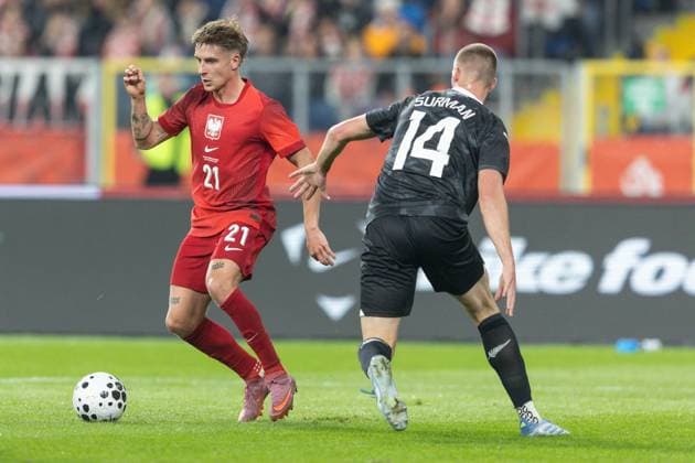 9th October 2025; Stadion Slaski, Chorzow, Poland; International Football, friendly match, Poland versus New Zealand; Michal Skoras (POL) skips the tackle from Finn Surman (NZA)  FotoxOlimpik